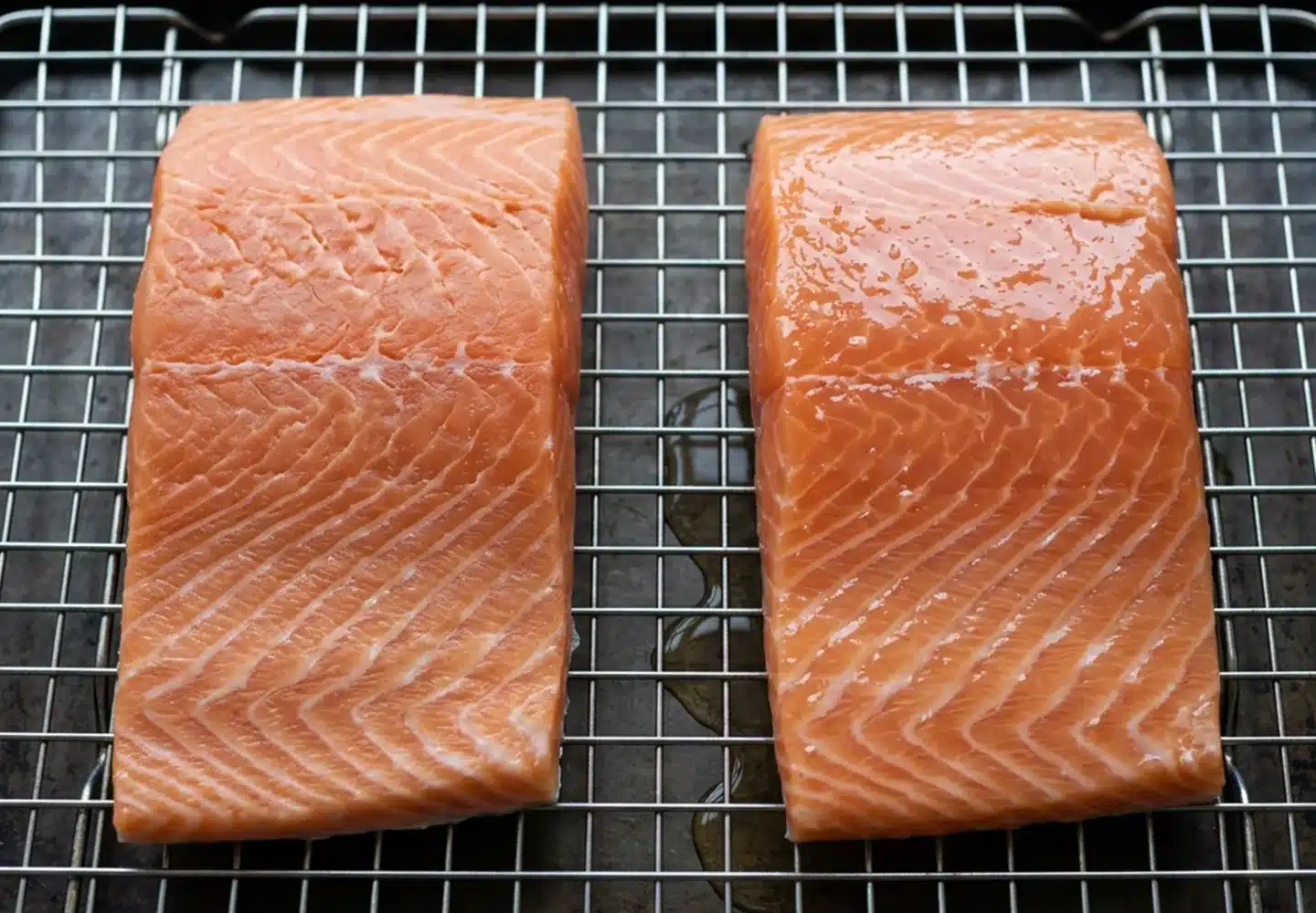 Two raw salmon portions on a rack, one with a dry matte surface and one visibly wet.
